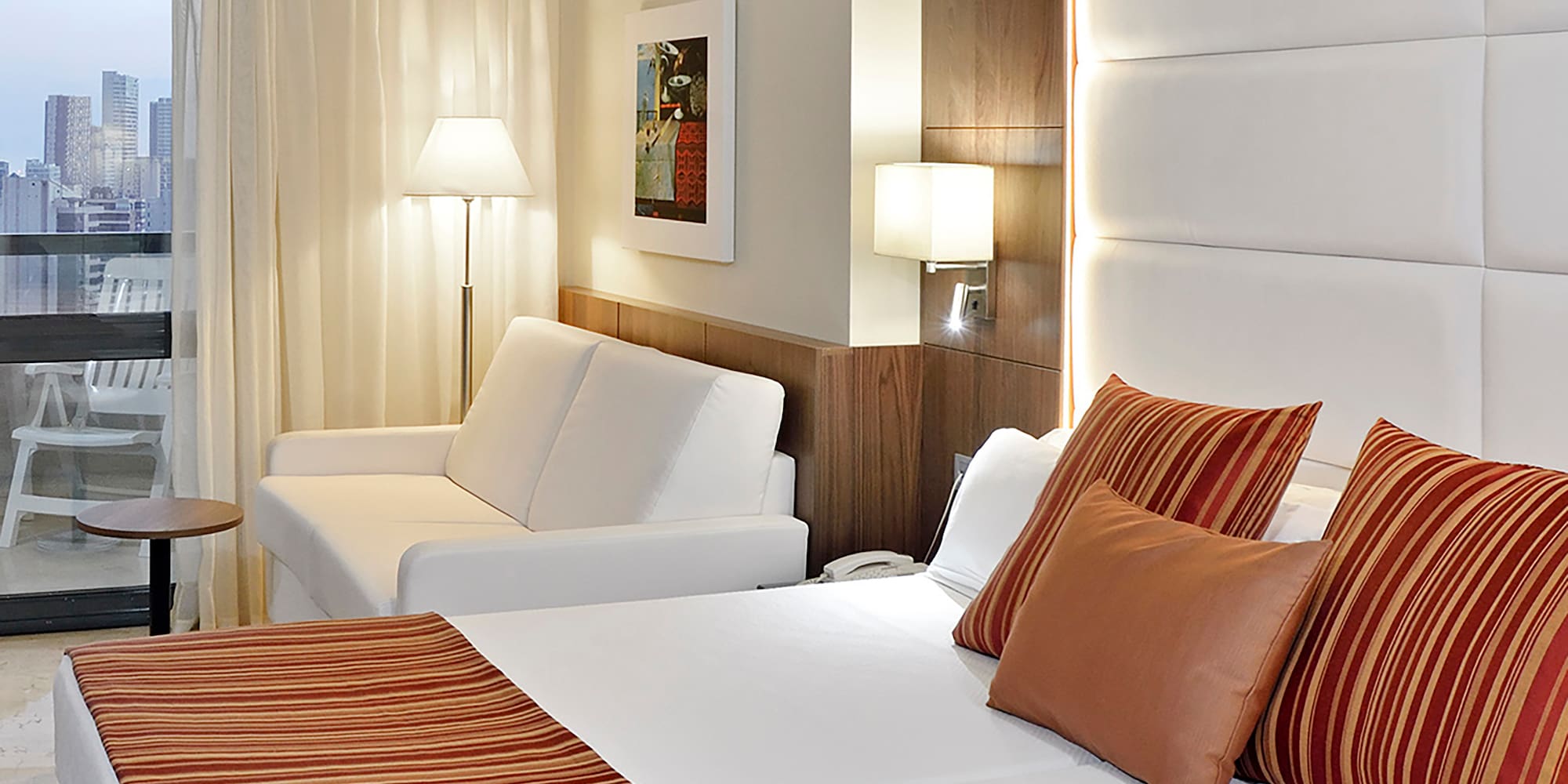 a bed and couch in a hotel room.