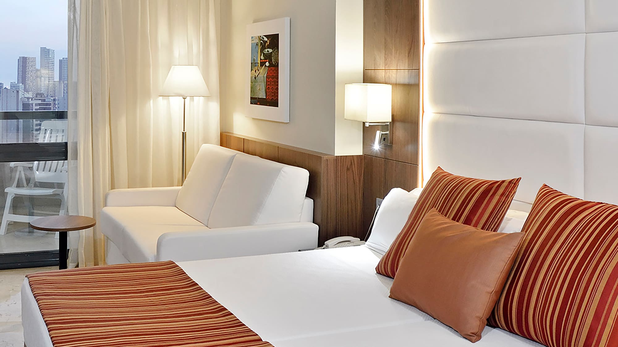 a bed and couch in a hotel room.