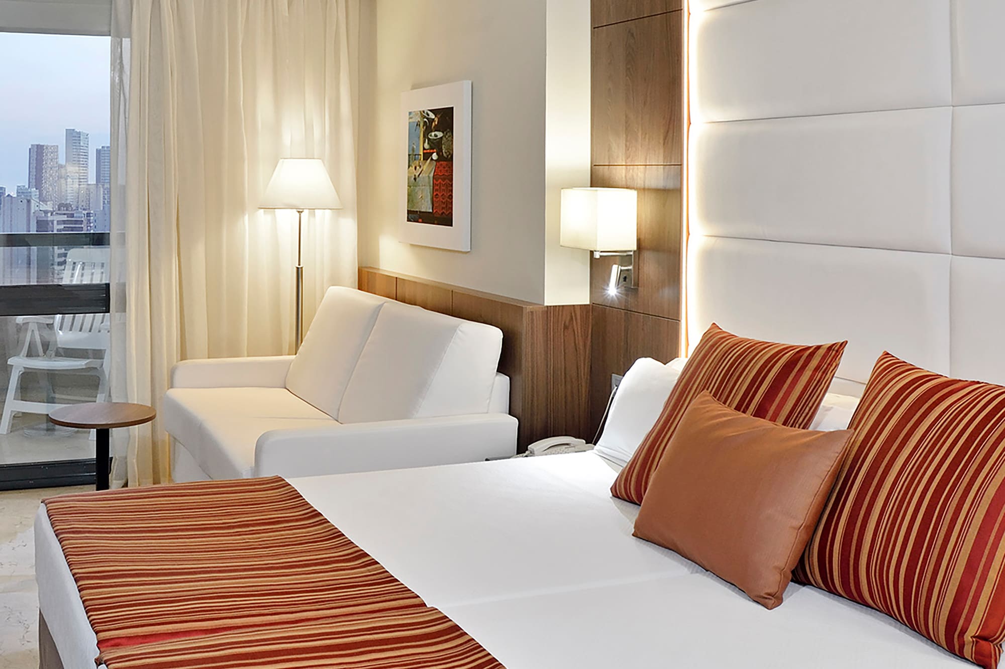 a bed and couch in a hotel room.