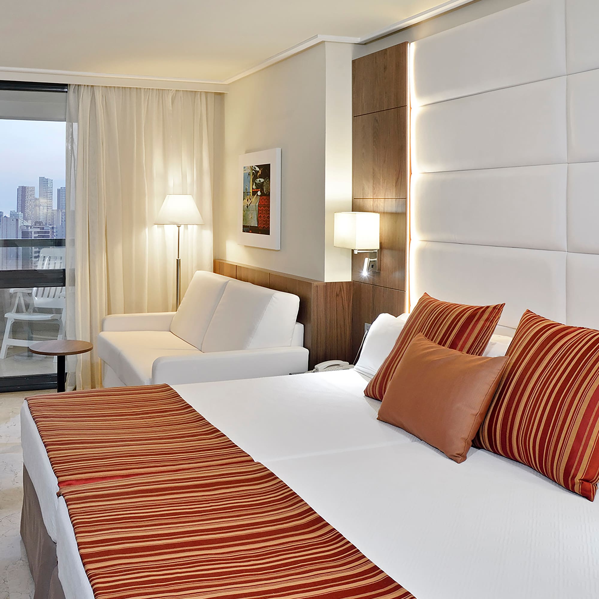 a bed and couch in a hotel room.