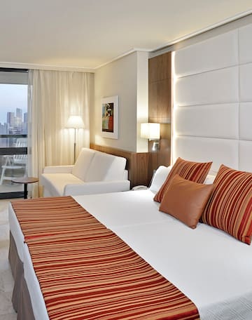 a bed and couch in a hotel room.