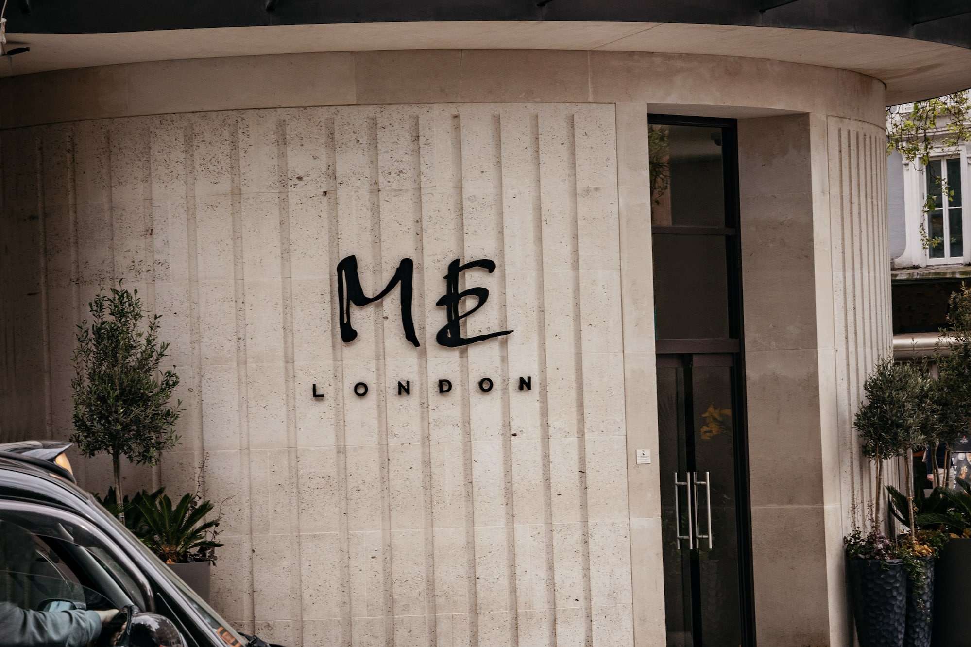 a black car parked in front of a building