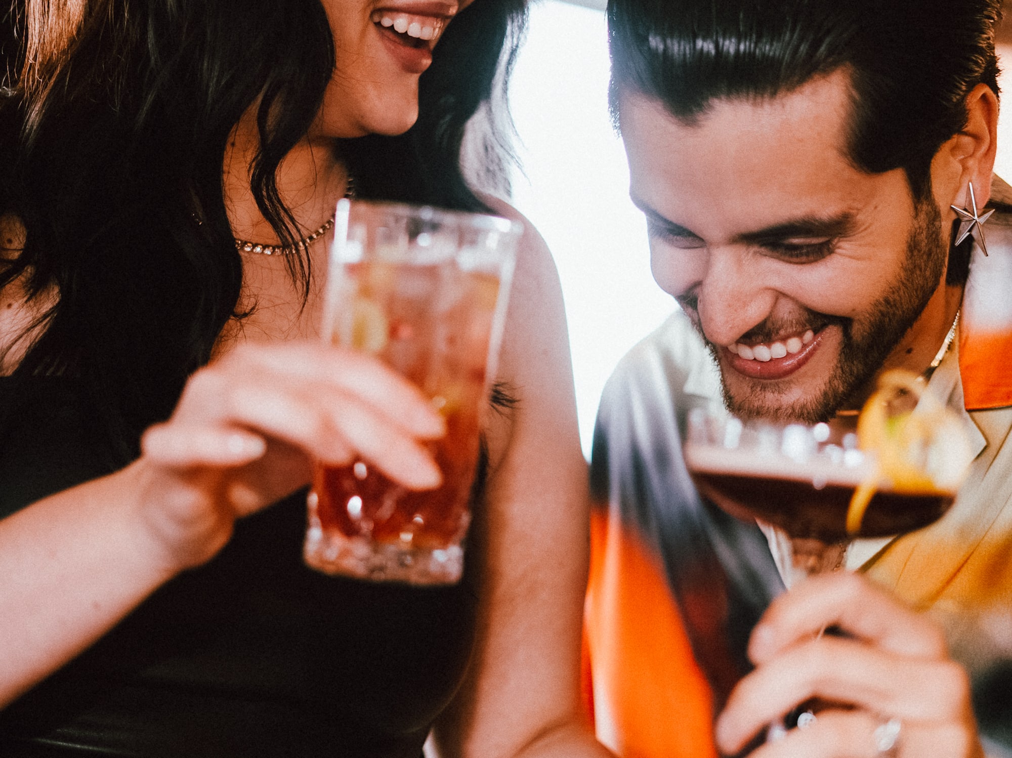 a man and woman holding drinks