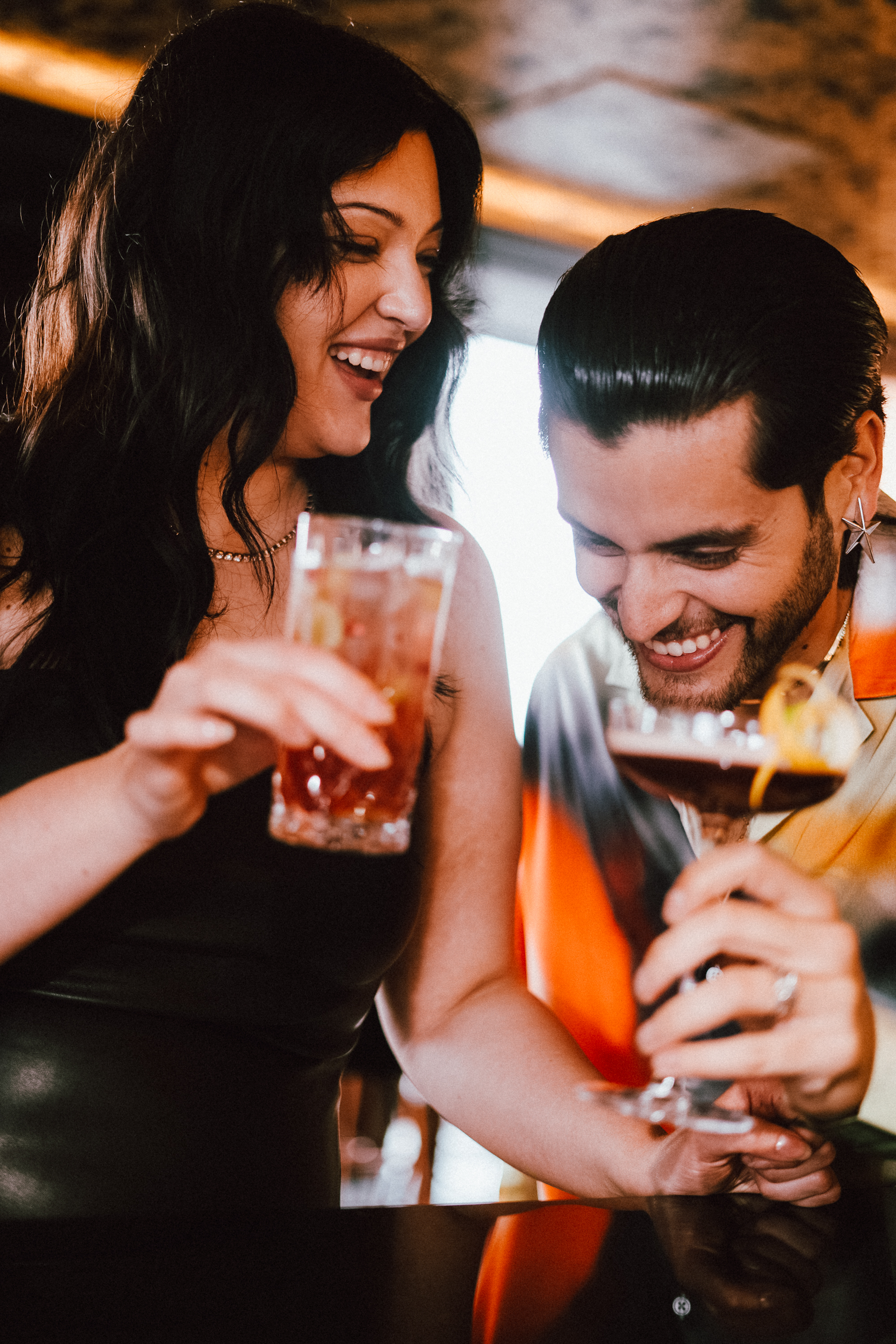 a man and woman holding drinks