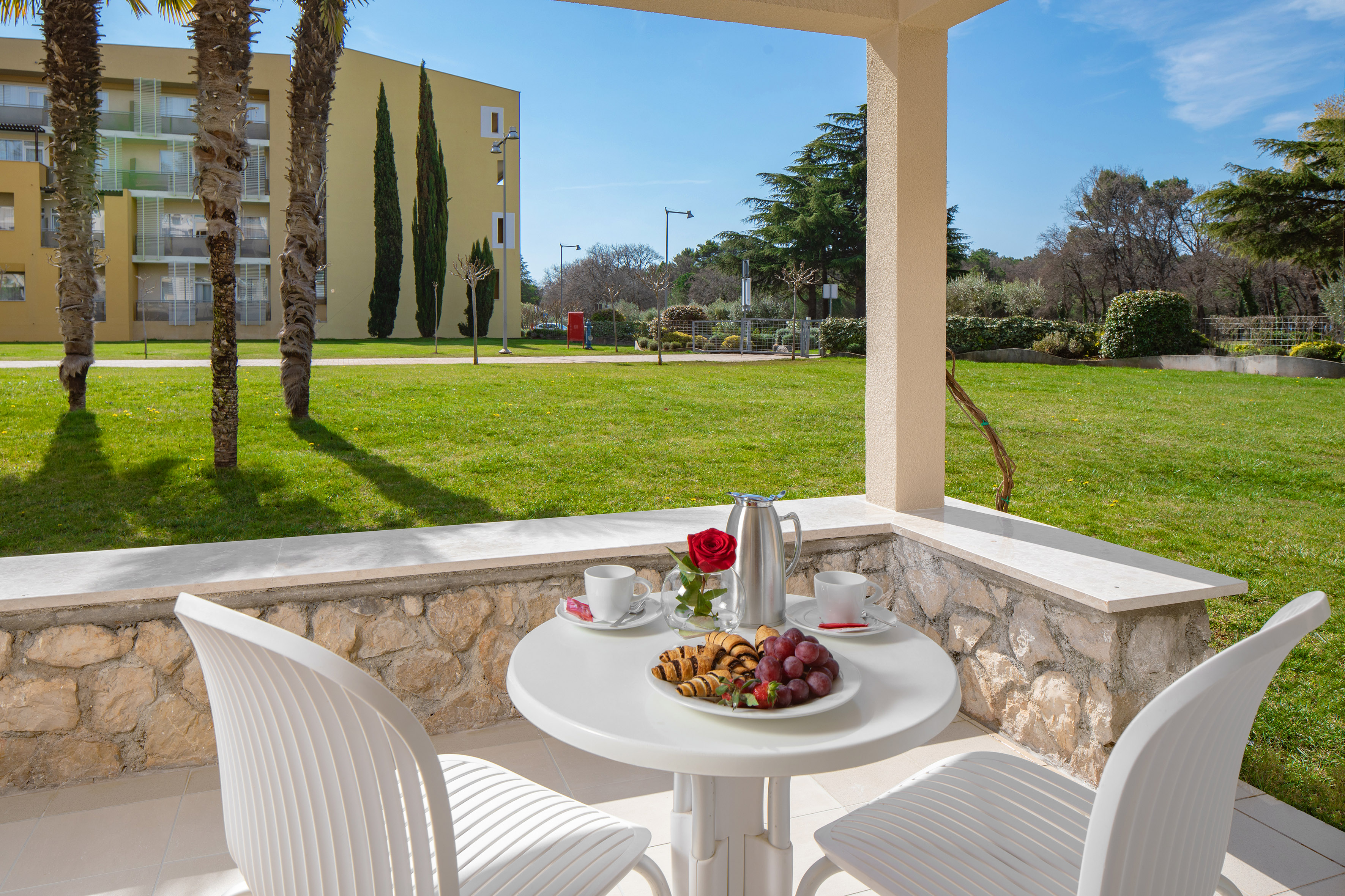 a table with food on it and chairs on a patio
