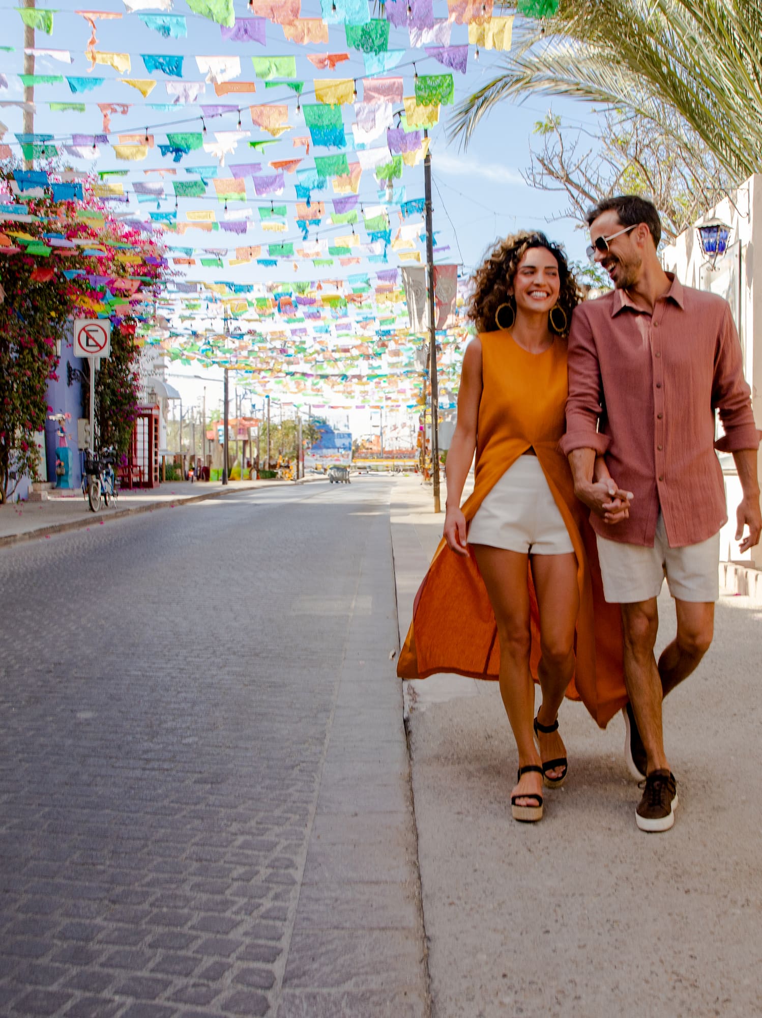 a man and woman walking on a street