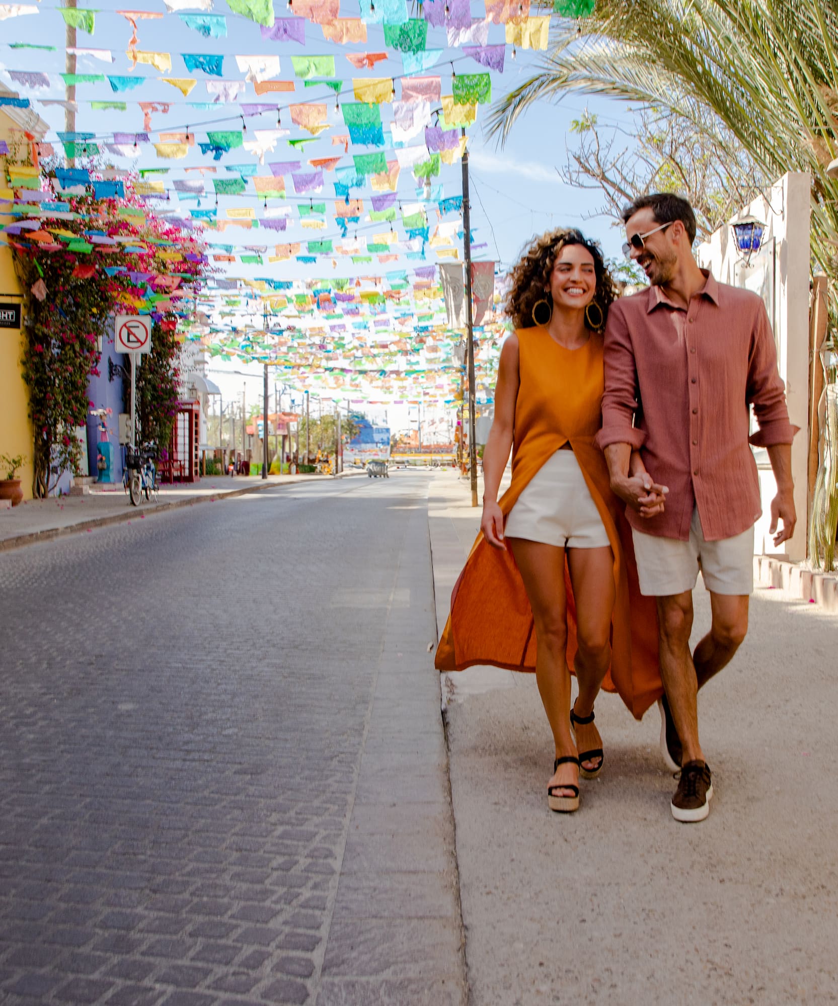 a man and woman walking on a street