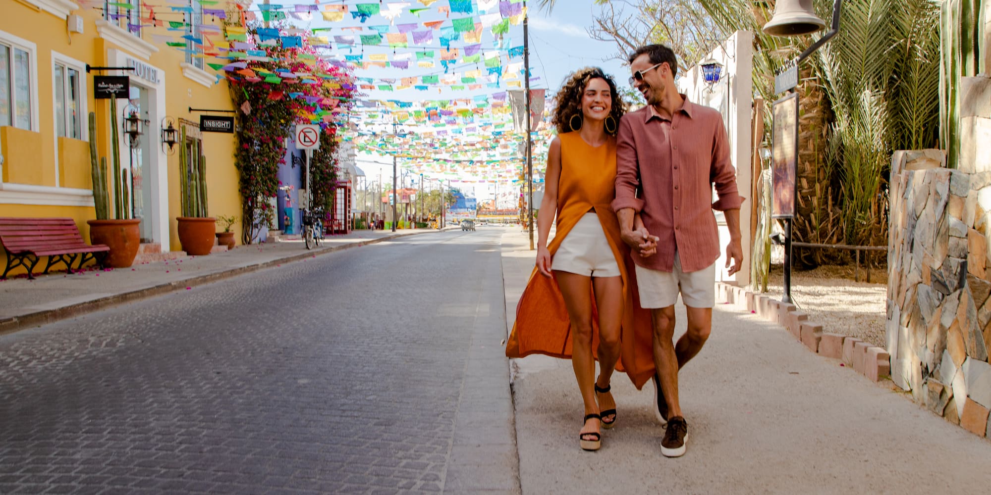 a man and woman walking on a street