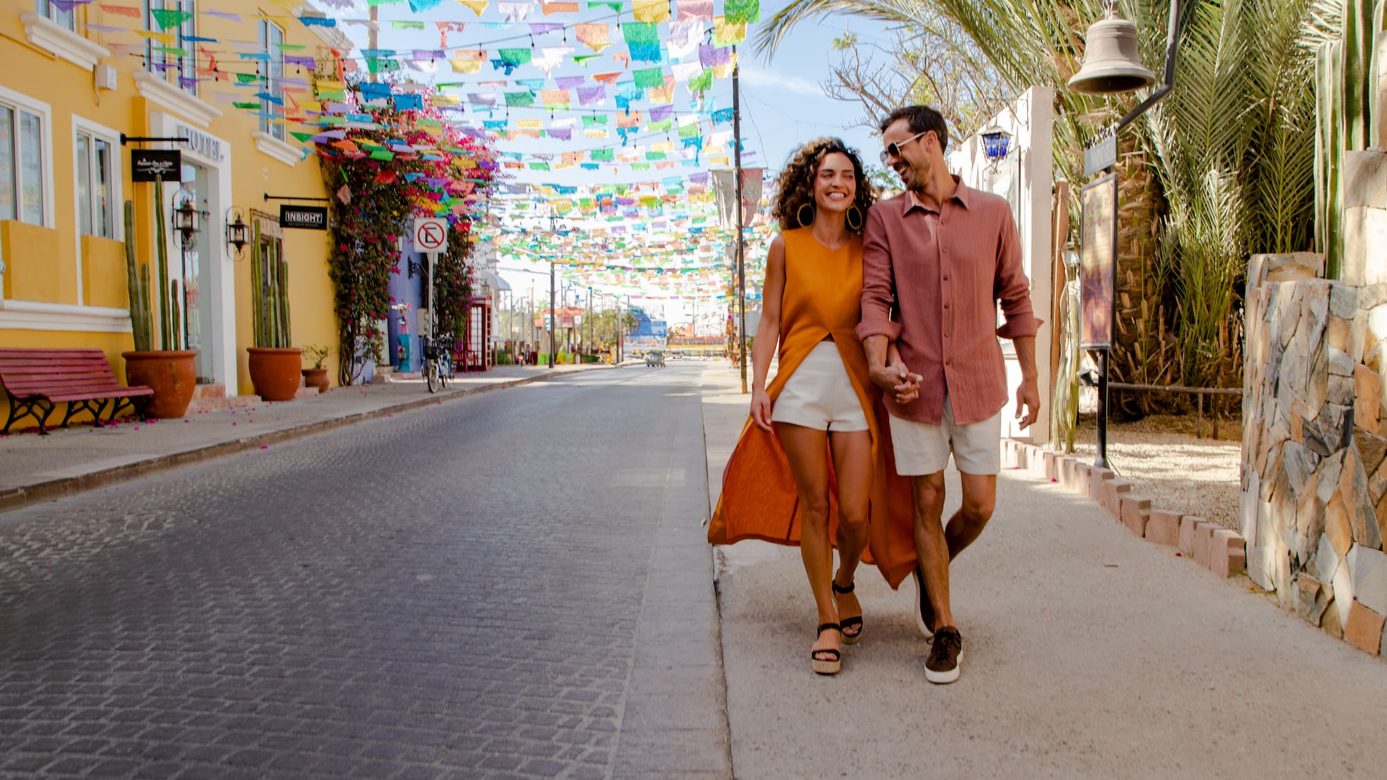 a man and woman walking on a street
