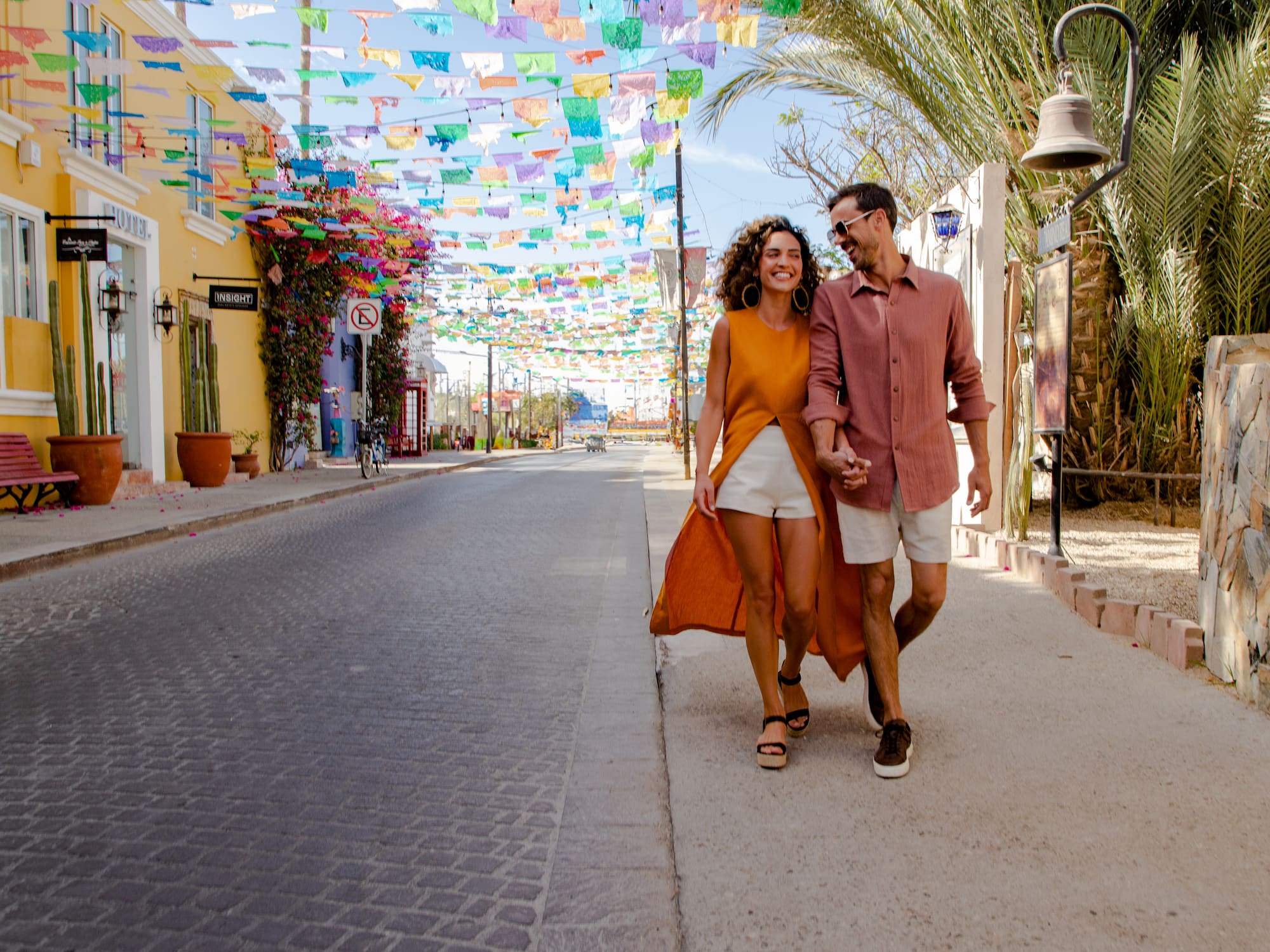 a man and woman walking on a street