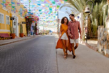 a man and woman walking on a street