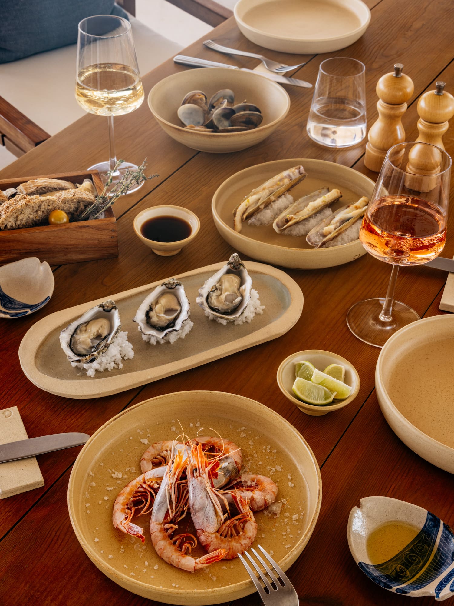 a table with plates of food and glasses of wine