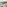 Hotel balcony ocean view with book, coastal town on cliffs, mountains.