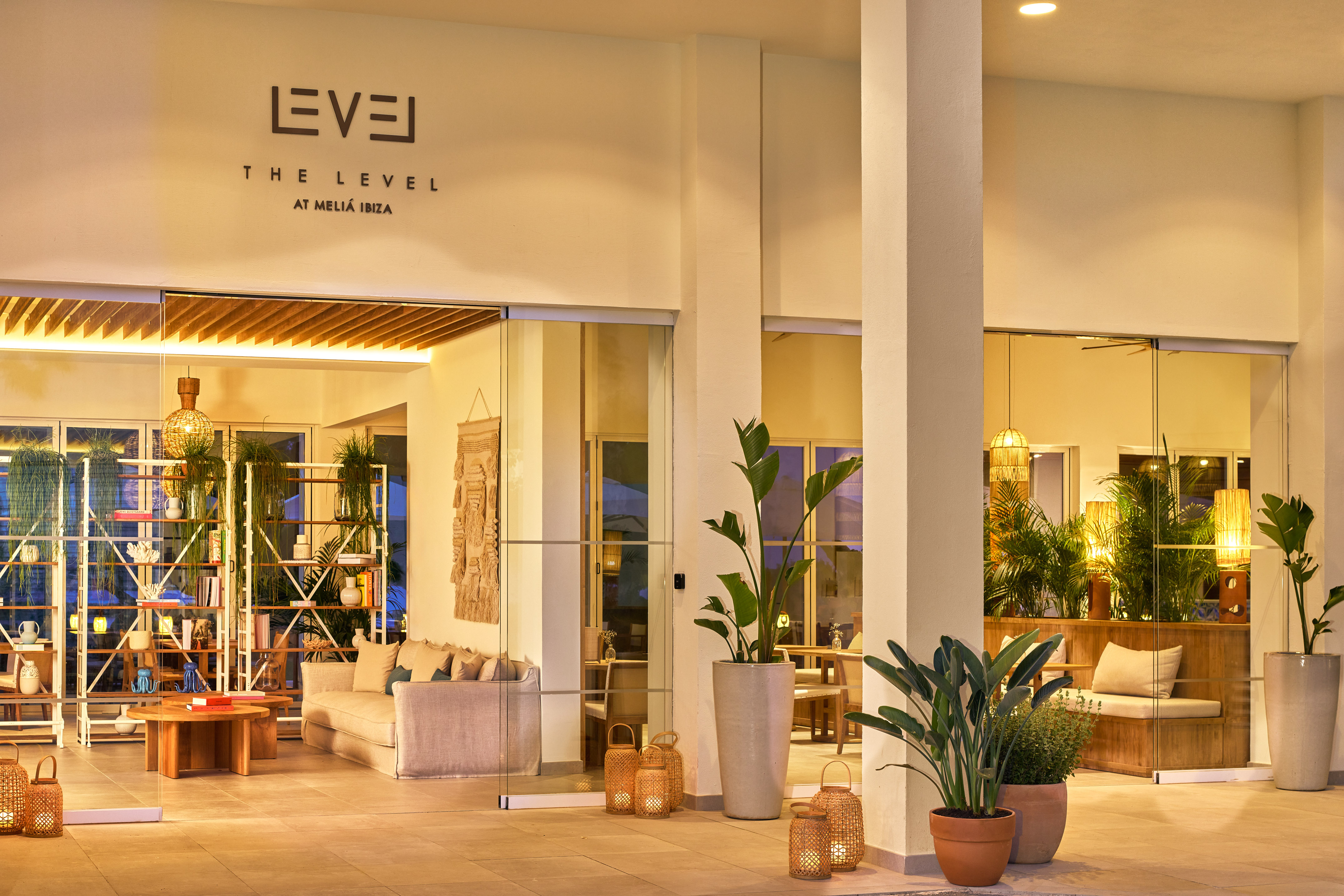 Meliá Ibiza The Level hotel entrance, stylish lounge with plants & warm lighting.