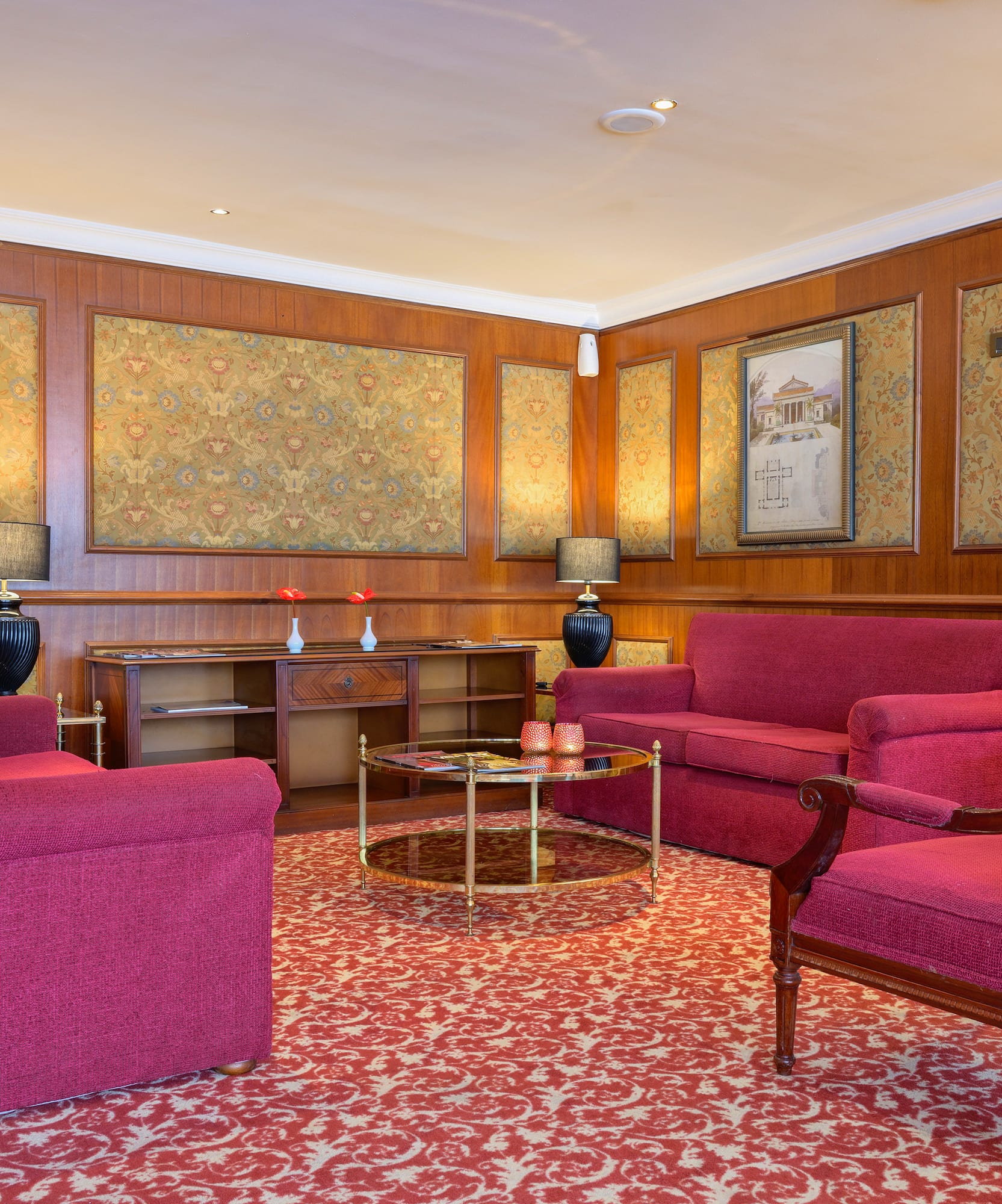 a room with red furniture and a table