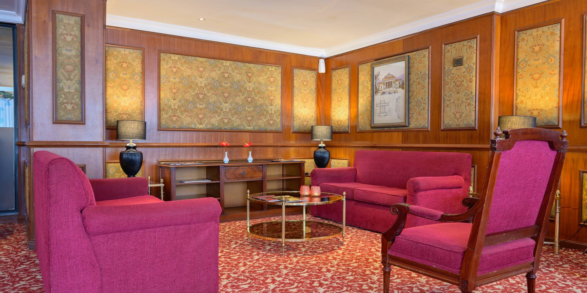 a room with red furniture and a table