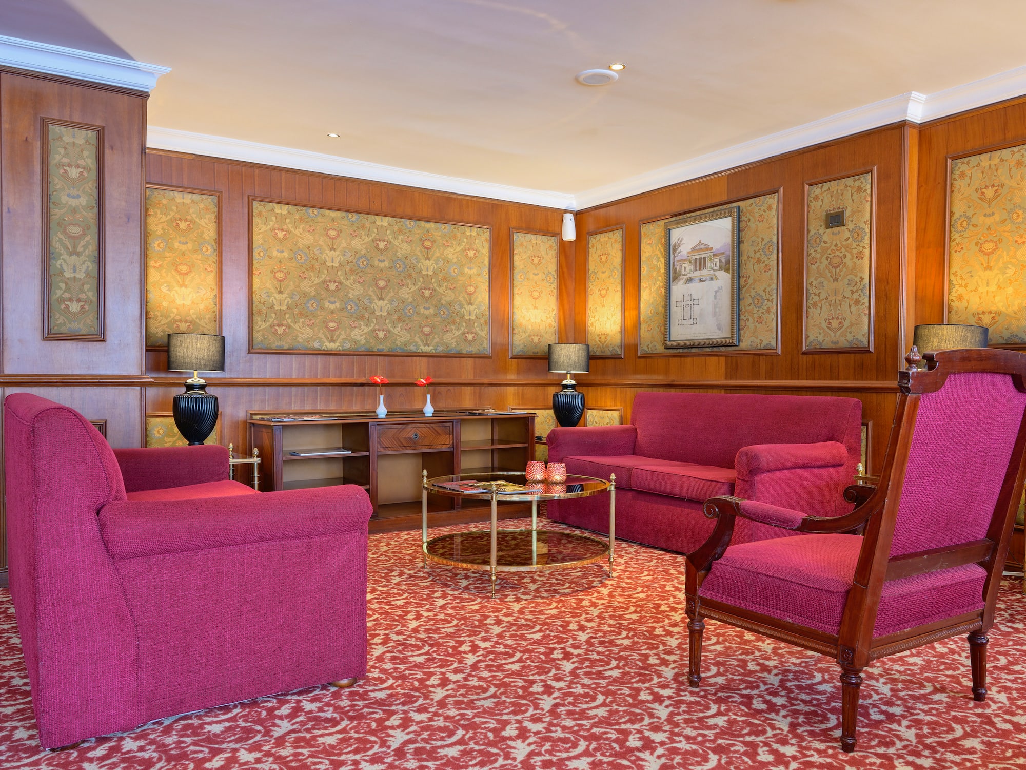 a room with red furniture and a table