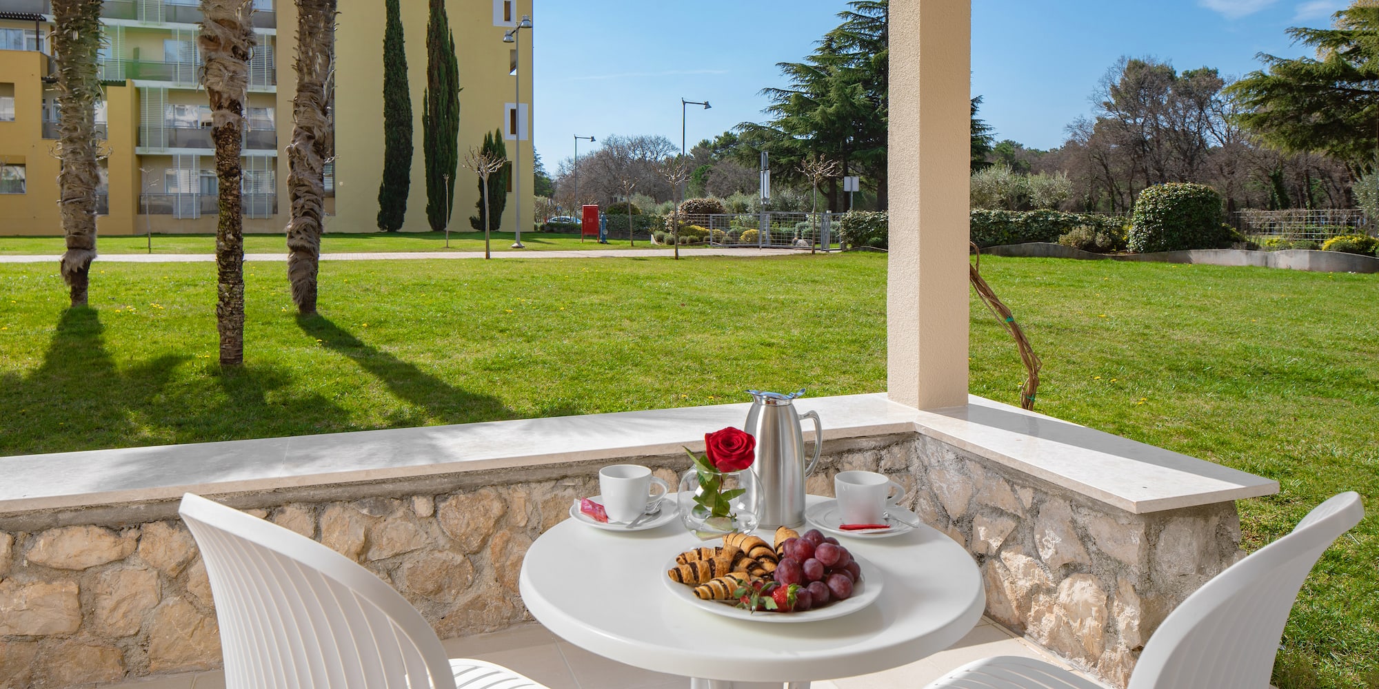a table with food on it and chairs on a patio