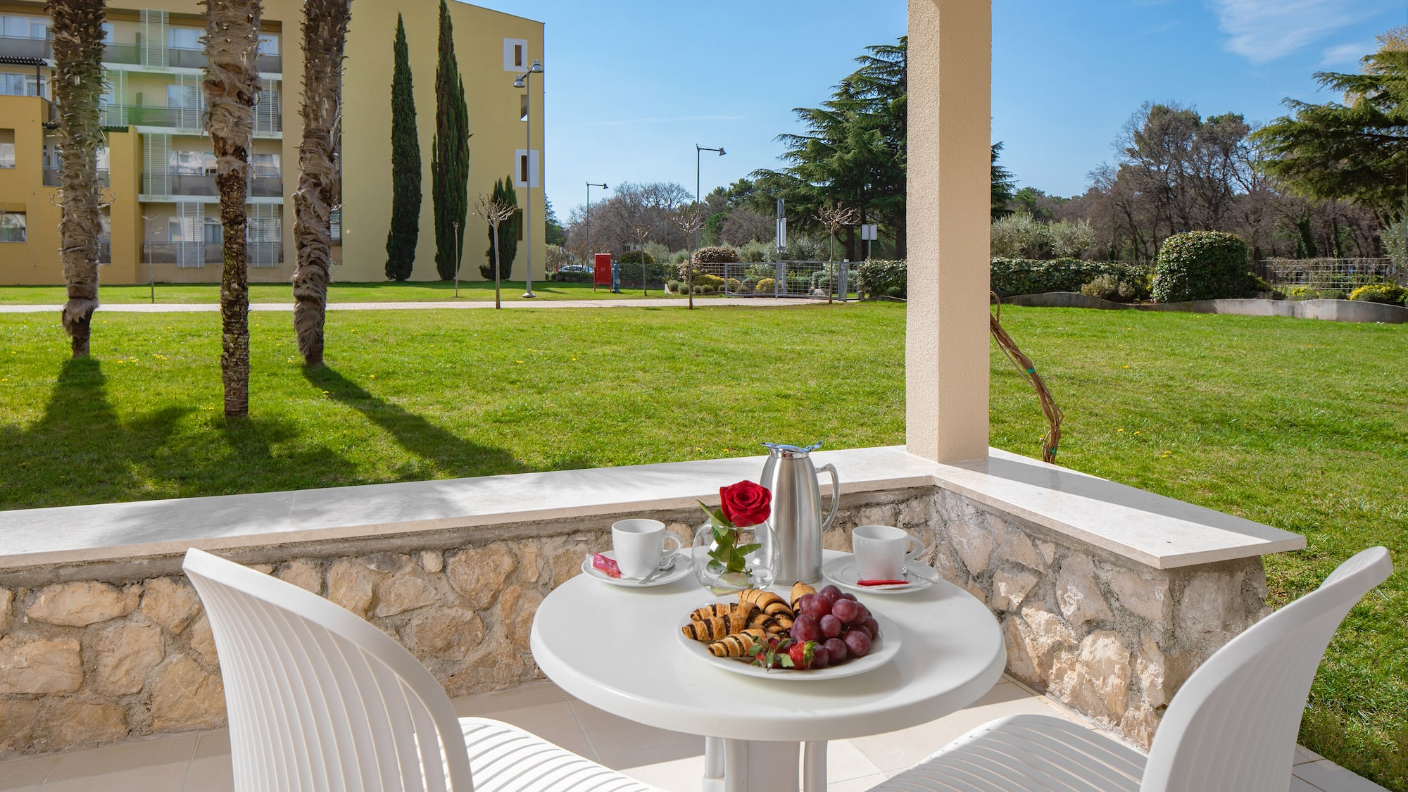 a table with food on it and chairs on a patio