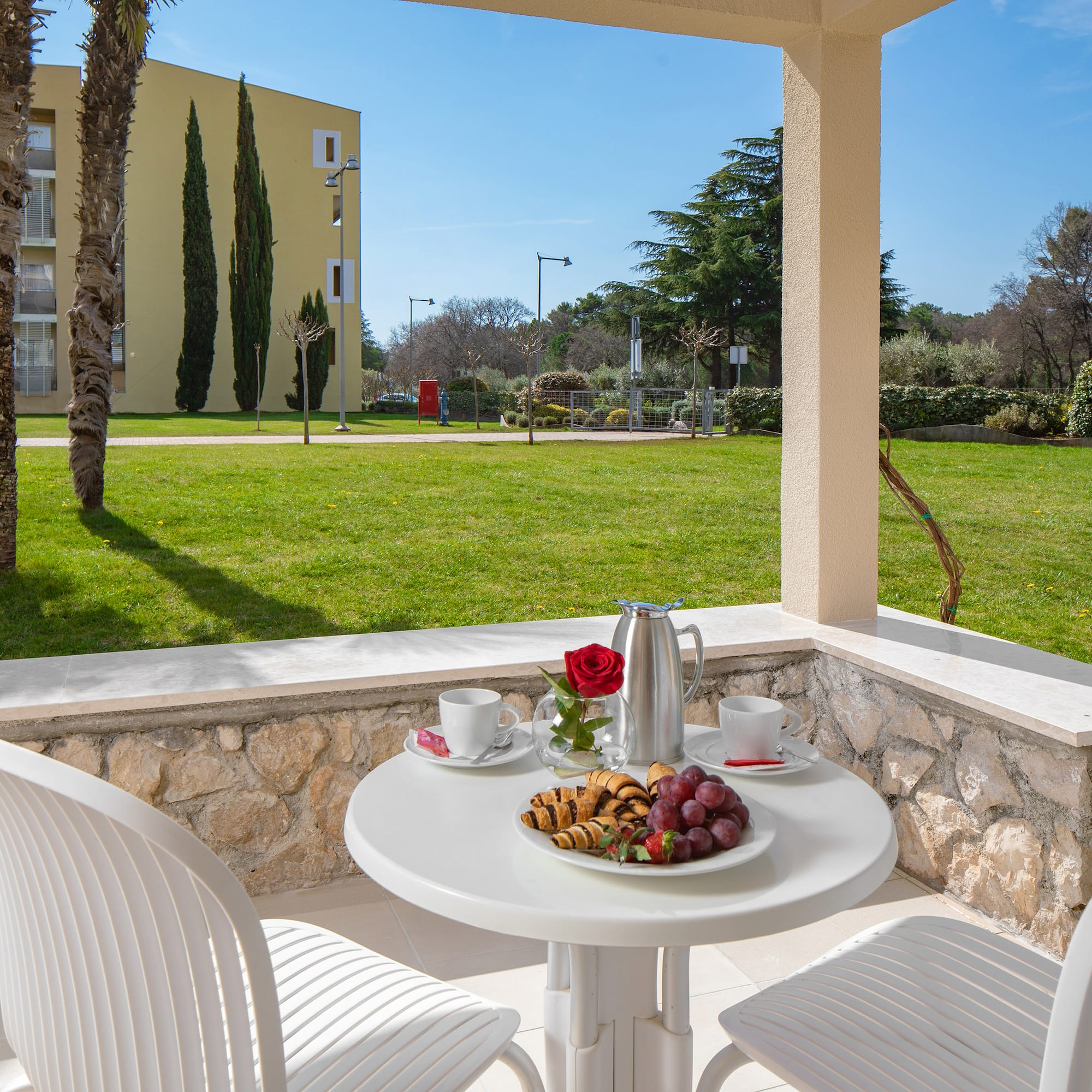 a table with food on it and chairs on a patio