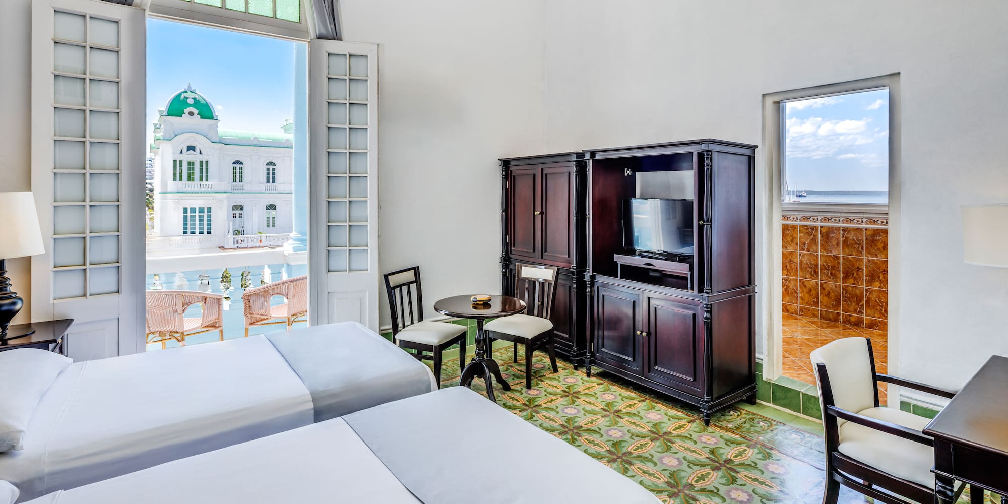 a room with two beds and a television