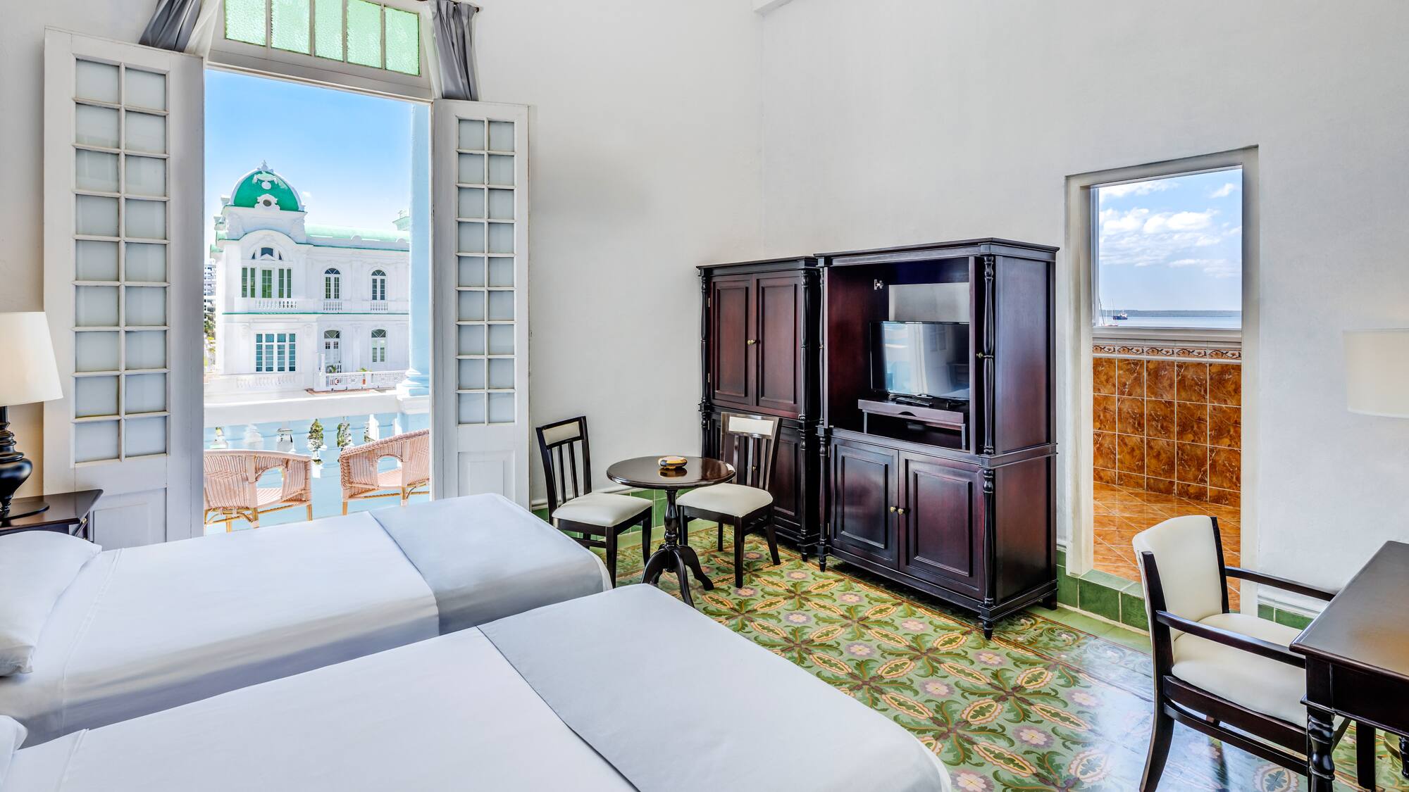 a room with two beds and a television