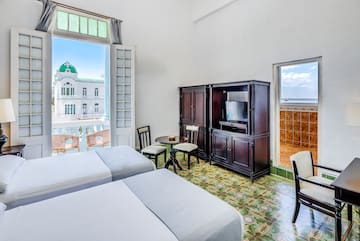 a room with two beds and a television