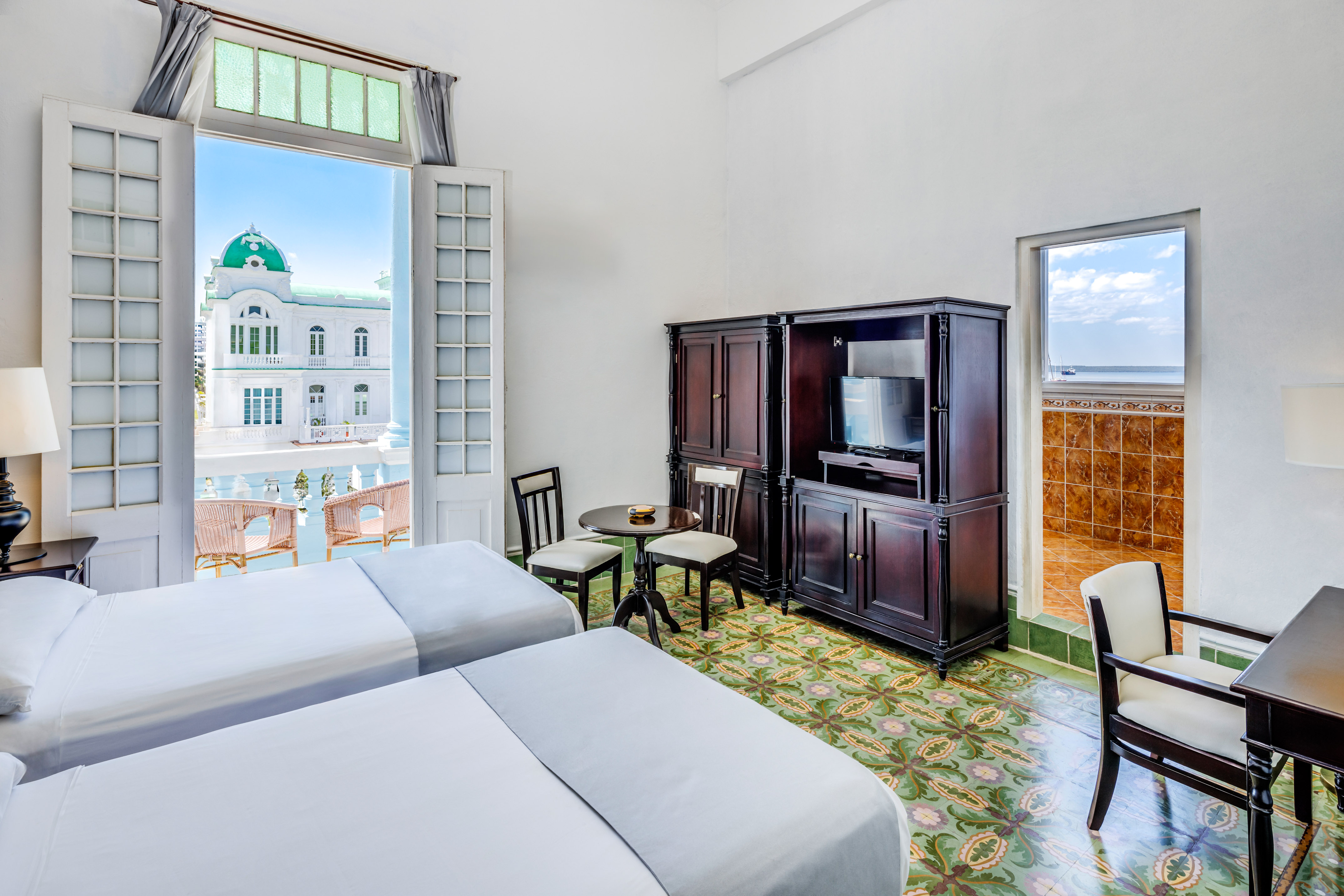 a room with two beds and a television