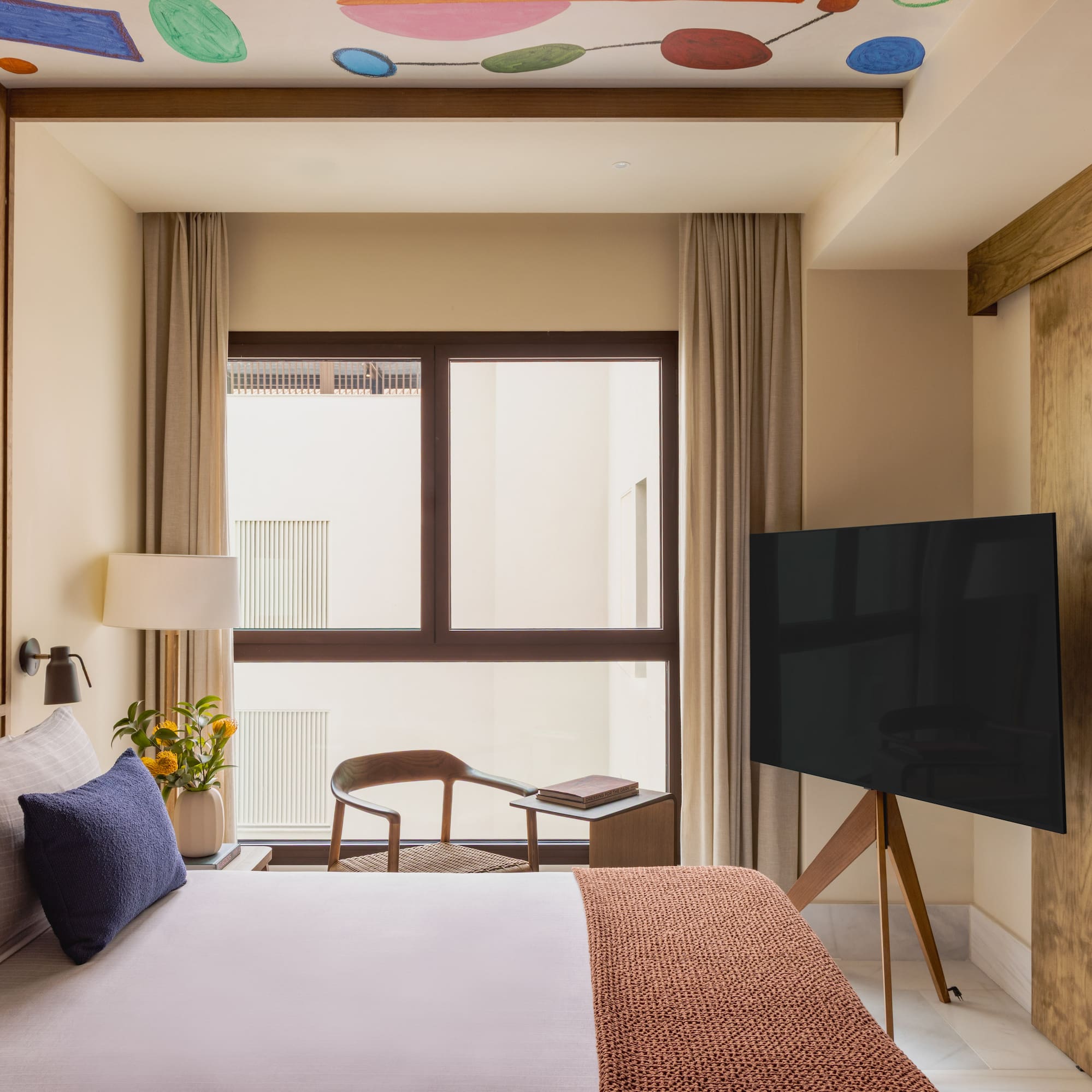 a room with a tv and a bed