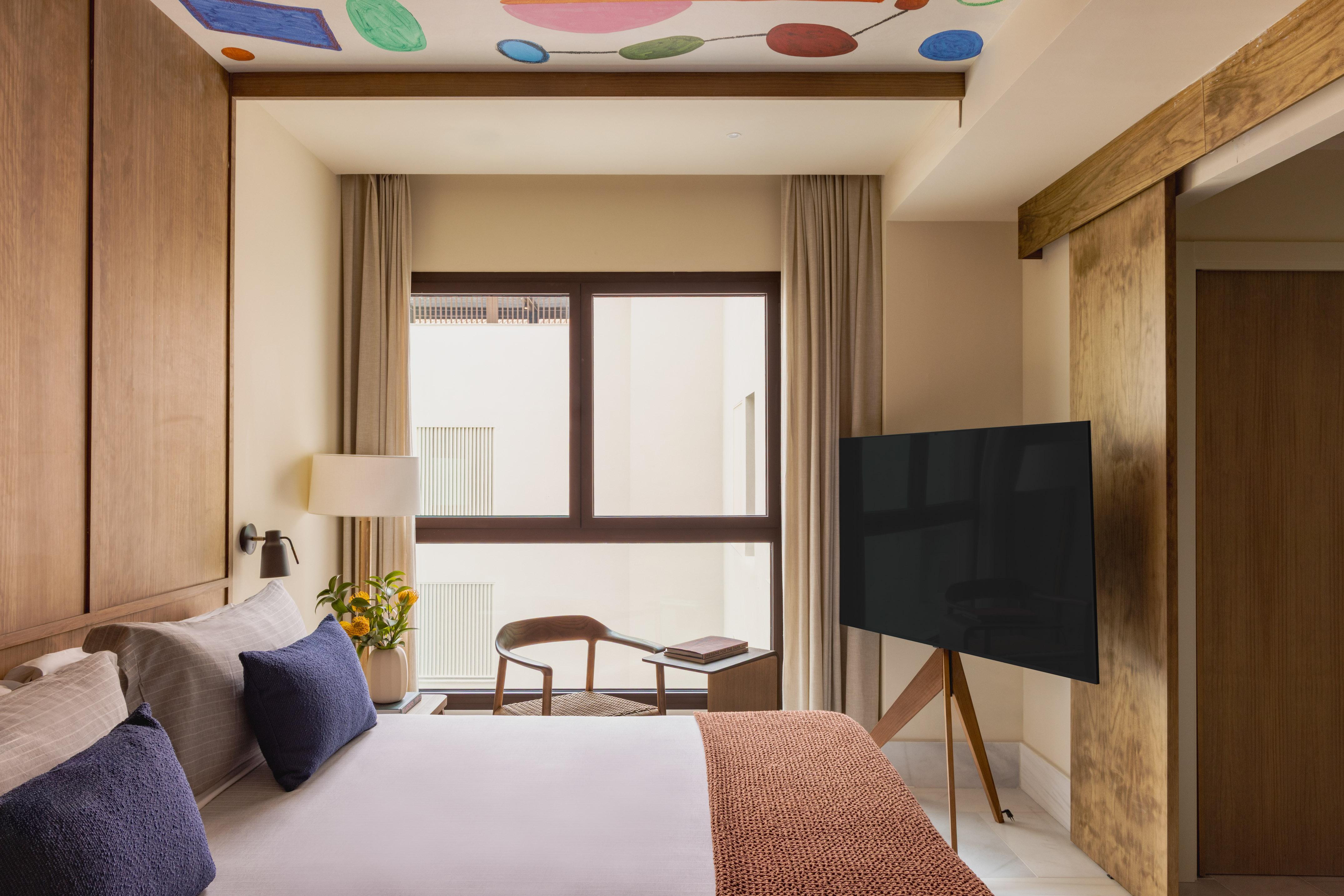 a room with a tv and a bed