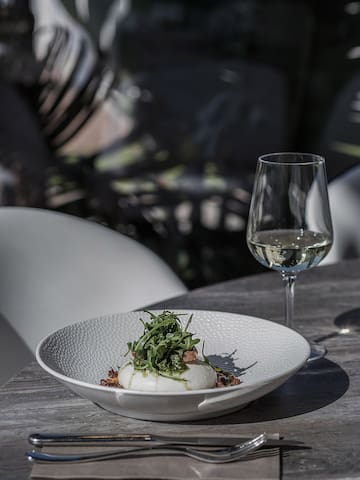 a plate of food and a glass of wine