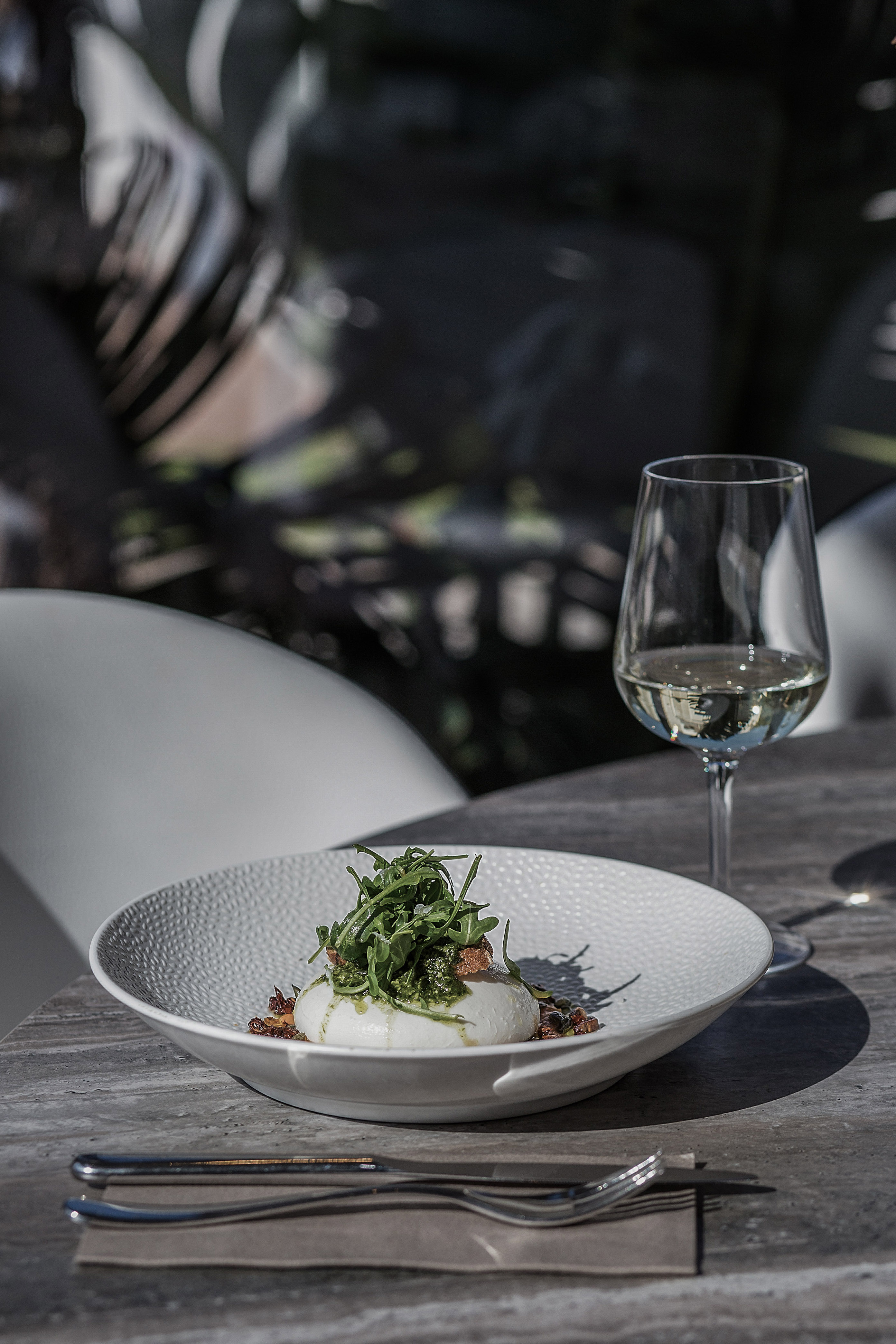 a plate of food and a glass of wine