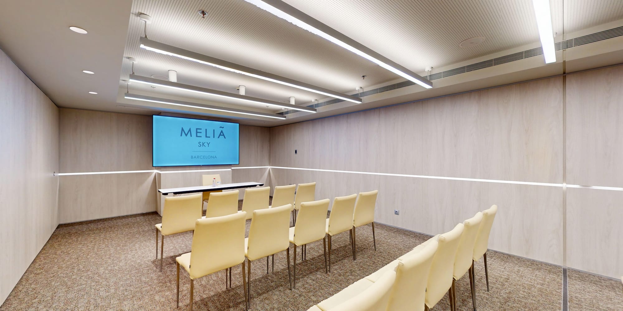 Meliá Sky Barcelona conference room with presentation screen and arranged seating.