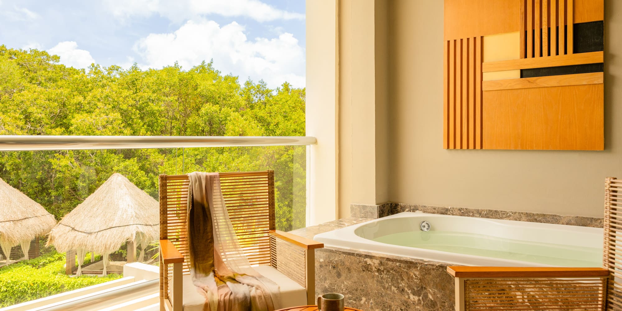 Balcony hot tub with jungle view, outdoor seating, and palapas.