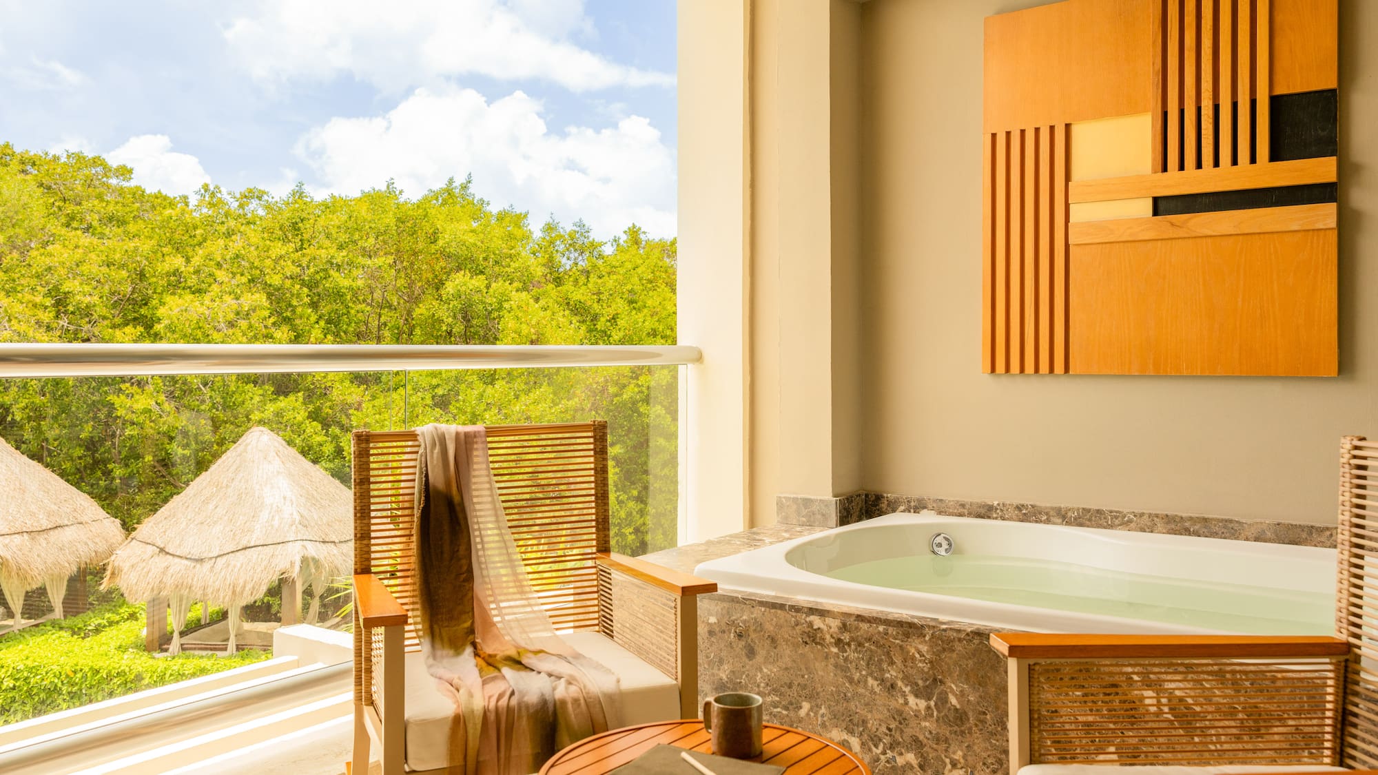 Balcony hot tub with jungle view, outdoor seating, and palapas.