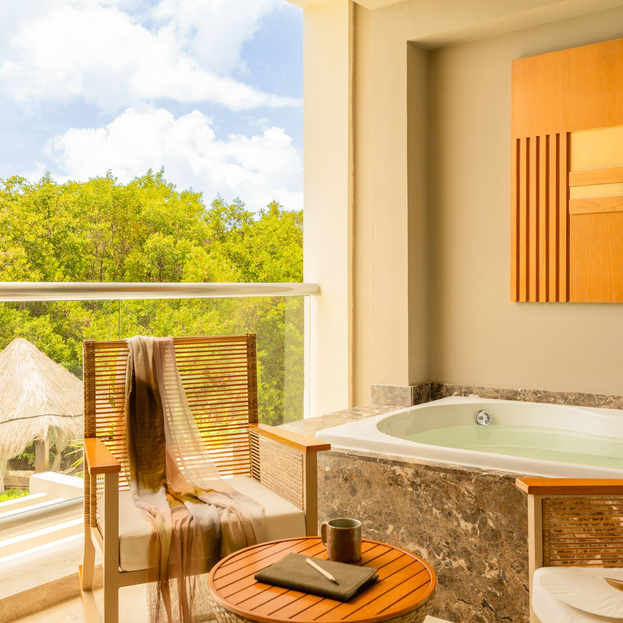 Balcony hot tub with jungle view, outdoor seating, and palapas.