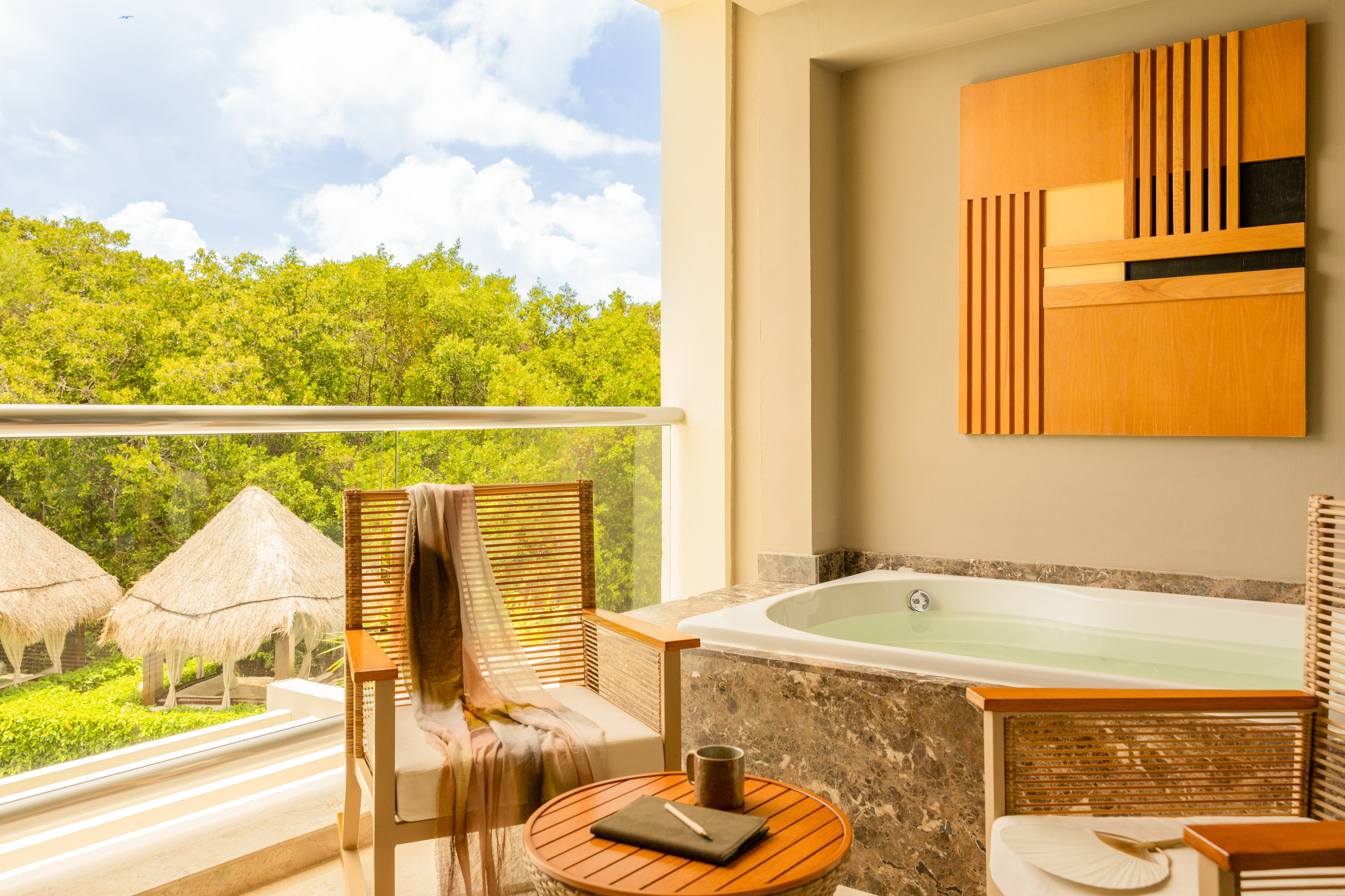 Balcony hot tub with jungle view, outdoor seating, and palapas.