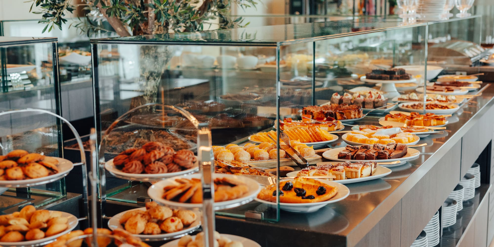 Extensive hotel dessert buffet with cakes, cookies, and pastries.