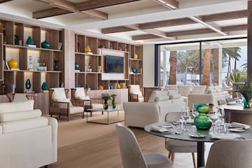 a room with a large wall and shelves with furniture