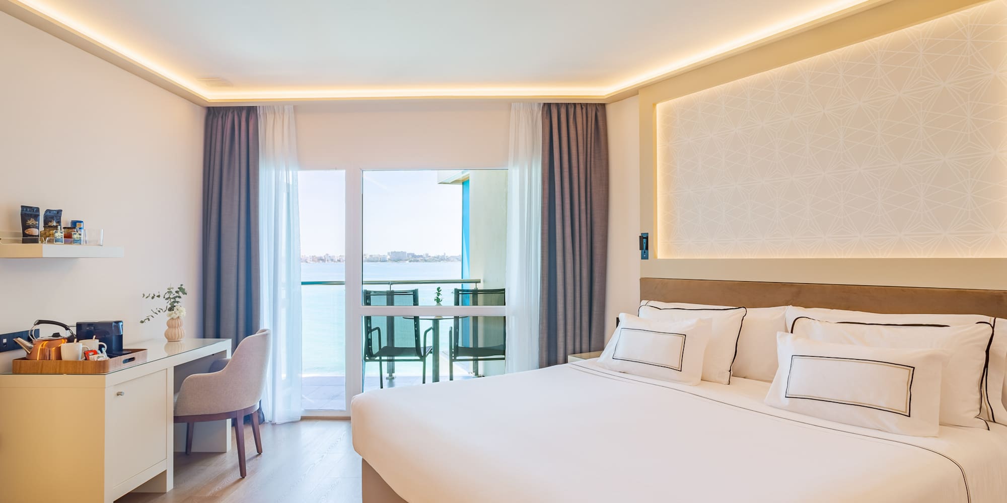 a room with a bed and a desk and chair