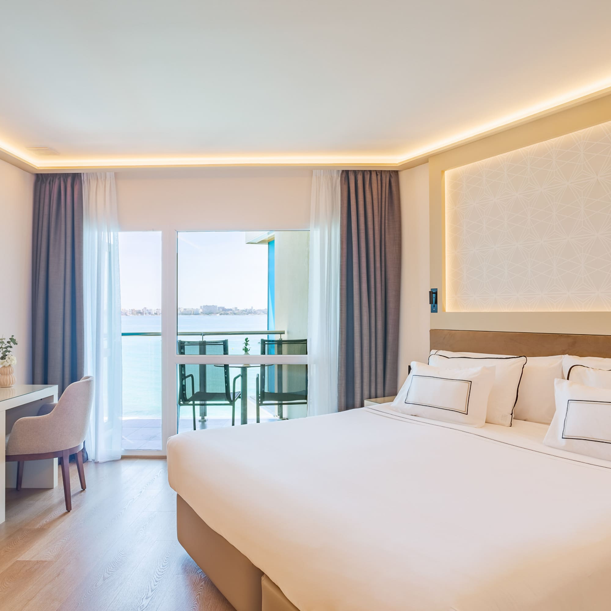 a room with a bed and a desk and chair