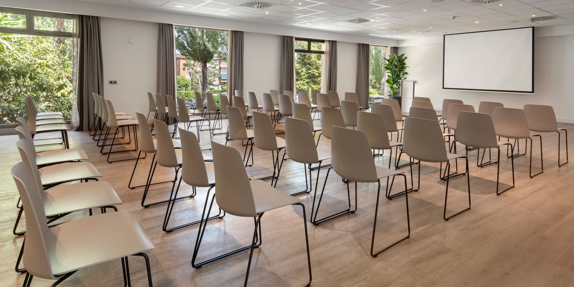 a room with chairs and a projector screen