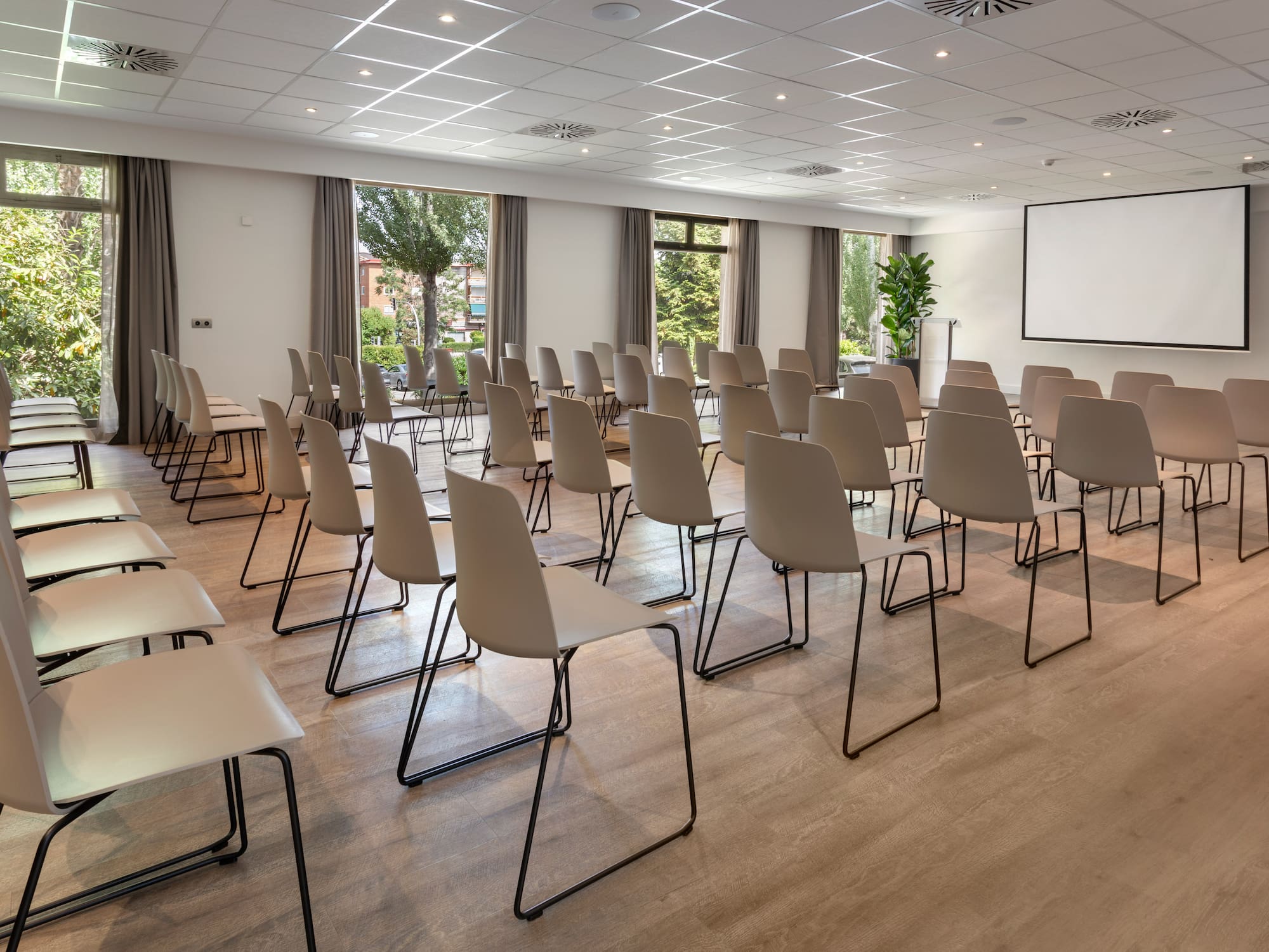 a room with chairs and a projector screen