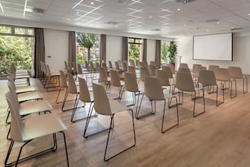 a room with chairs and a projector screen