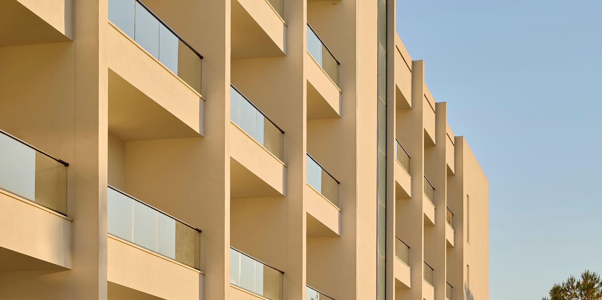 a building with balconies and trees