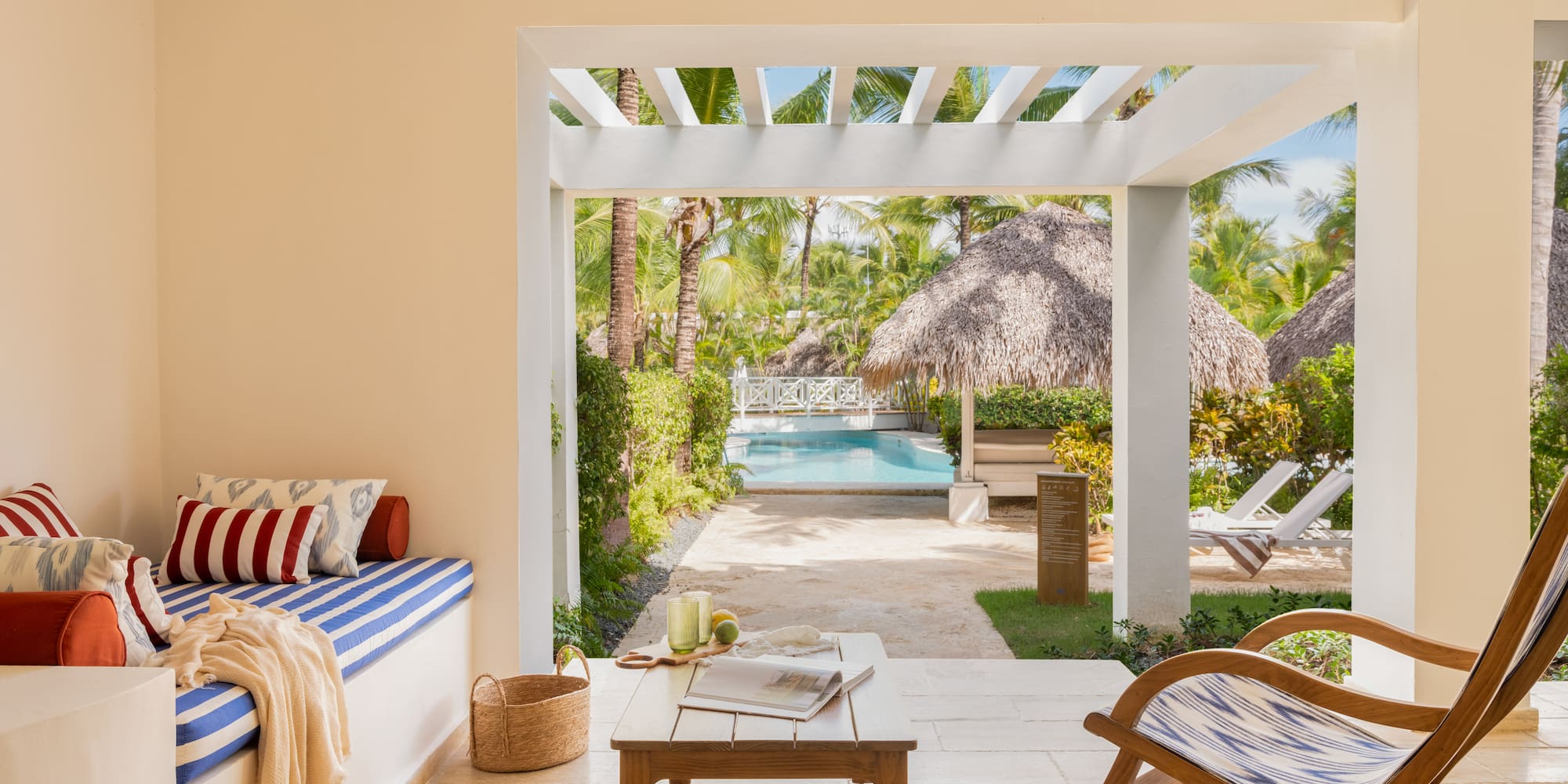 a room with a pool and chairs