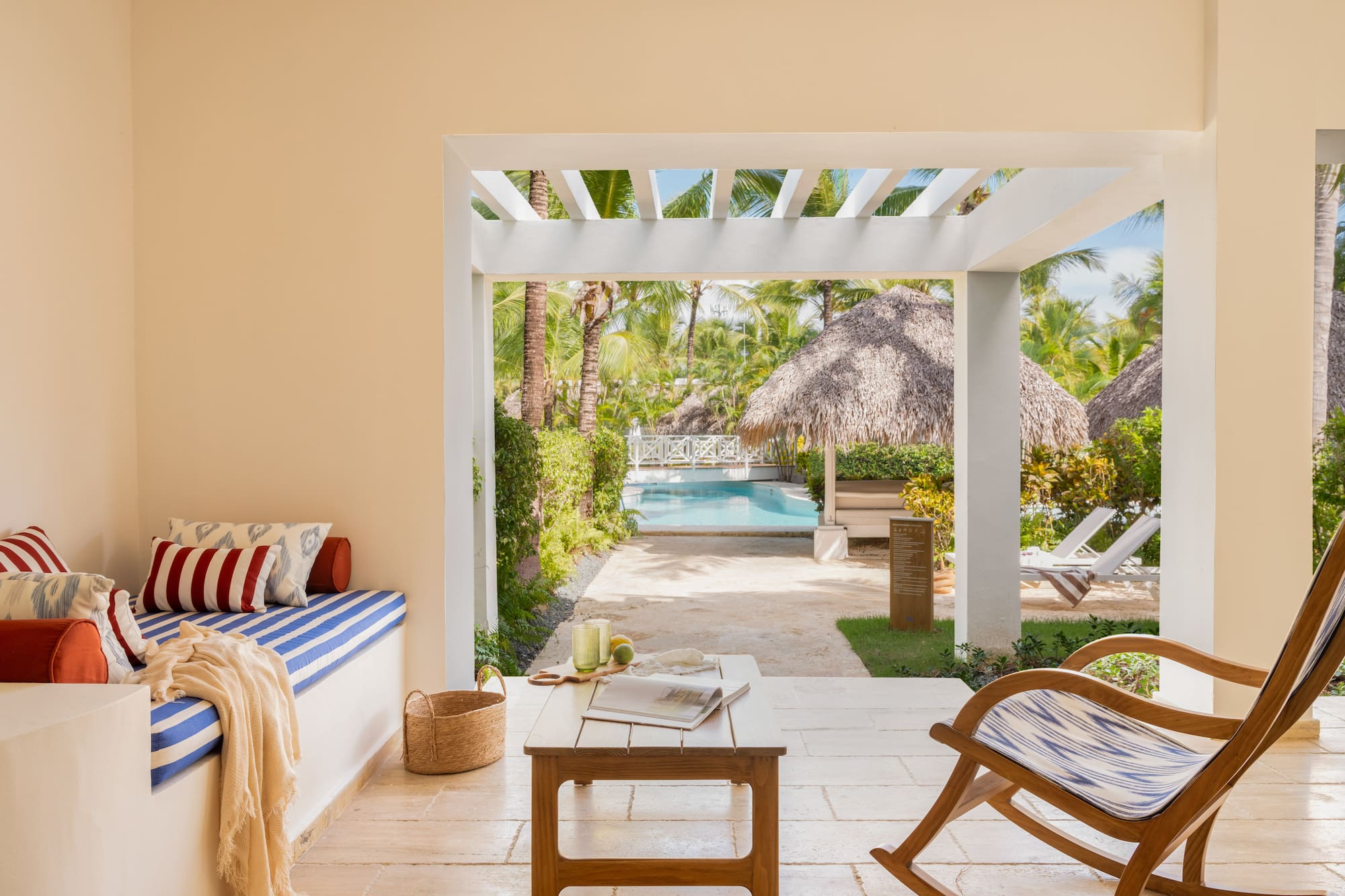 a room with a pool and chairs