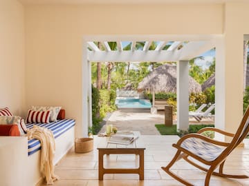 a room with a pool and chairs
