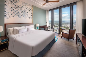 a bedroom with a large window and a large bed