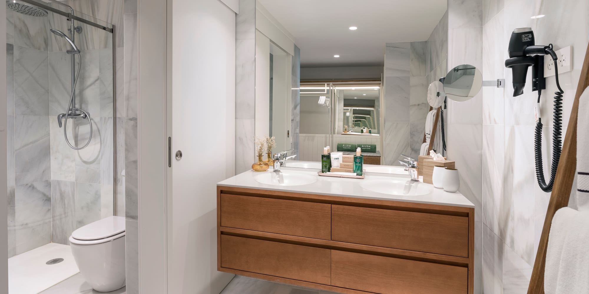 a bathroom with a large mirror and a sink